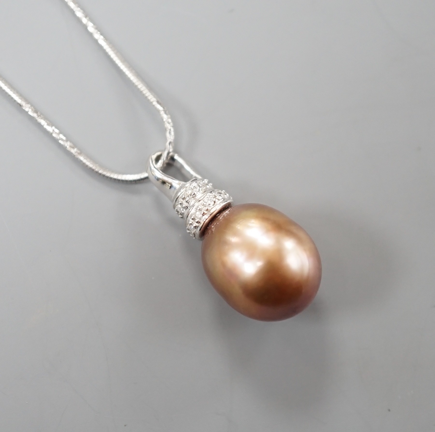 A modern 750 white metal South Sea culture pearl and diamond chip set pendant necklace, overall 48cm, gross weight 7.2 grams.